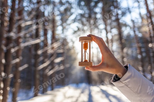Preview: Hourglass in the snow. Spring is coming. melting snow