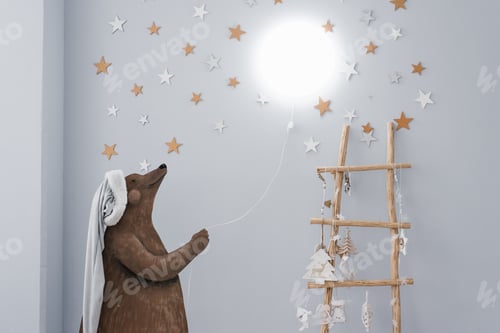 Preview: Creative lamp in the children's room. The drawn bear holds in his hands a rope with a lamp