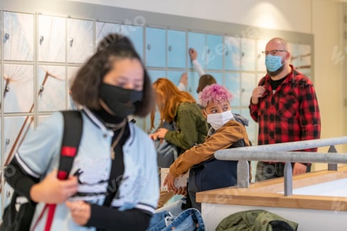 Preview: Mixed race teenage students walking through the school to their next class