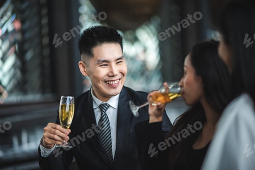 Preview: Cheers! Group of people cheering with champagne flutes in pub interior background
