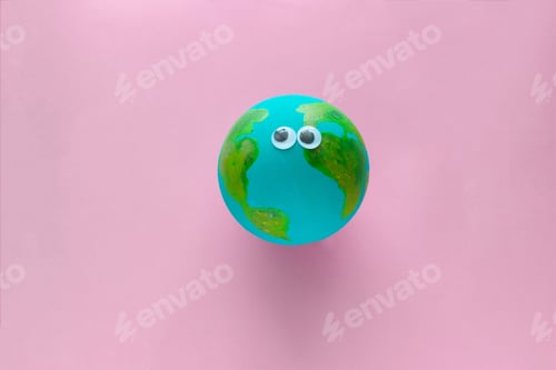 Preview: Earth planet model with googly eyes on a pastel pink background