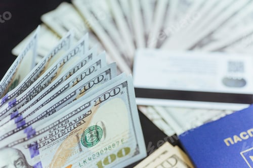 Preview: Top view of passport with dollar banknotes on wooden desktop