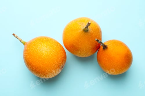 Preview: Ripe yellow passion fruits on light blue background, flat lay
