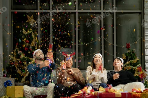Preview: men and women using paper shoot in a party at living room.