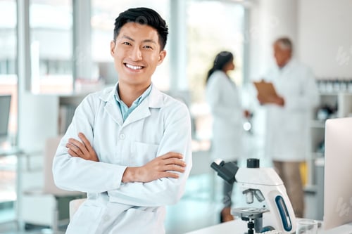 Preview: Portrait of a young scientist standing with his arms crossed in a lab