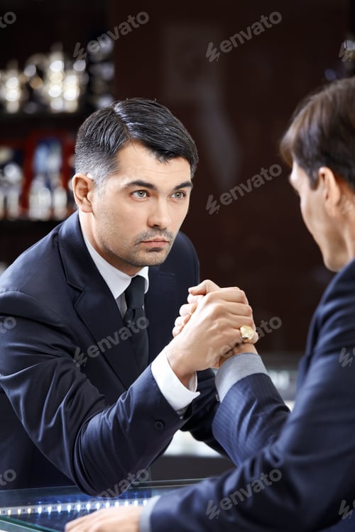 Preview: The businessmen arm-wrestling