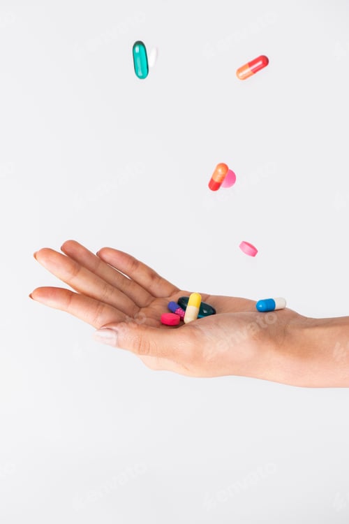 Preview: Colorful pills falling to a palm