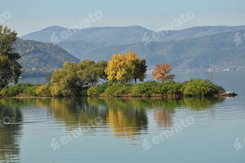 Preview: Small island in a river with autumn colors
