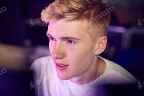 Preview: View Between Computer Screens Of Teenage Boy Gaming At Home