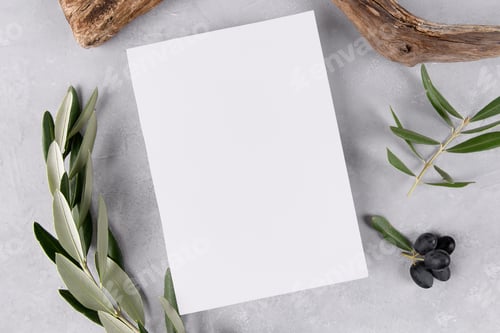 Preview: blank invitation stationery card mockup on grey stone table background with olive leaves
