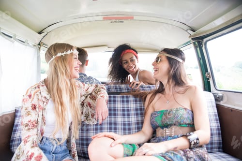 Preview: Happy friends driving a vintage minivan