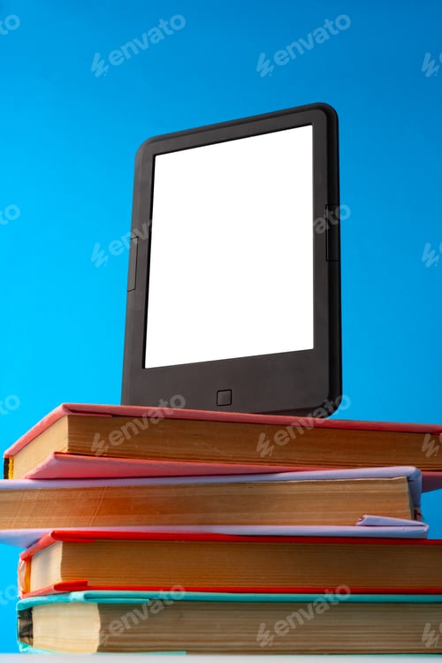 Preview: Modern e-book on stack of hardcover books on blue background