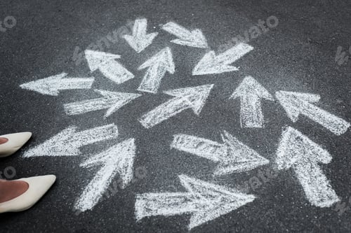 Preview: cropped view of woman standing near directional arrows on asphalt