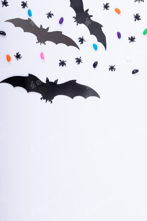 Preview: Composition of halloween decorations with spiders, bats and sweets on white background