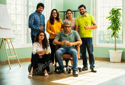 Preview: Confident Indian Asian business team in casuals, smiling, celebrating success in modern workspace