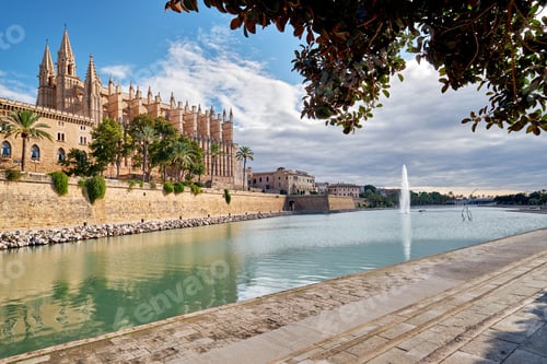 Preview: Low-angle view of the Cathedral La Seu and pool with a fountain in Mallorca, Spain