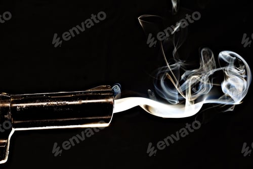 Preview: Closeup shot of a smoking gun with s black background
