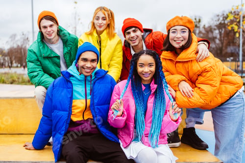 Preview: Multiracial group of young friends meeting outdoors in winter