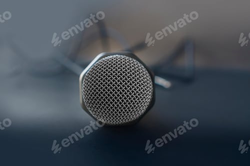 Preview: Microphone for karaoke with a wire isolated on black. top view, flat lay, copy space for your text