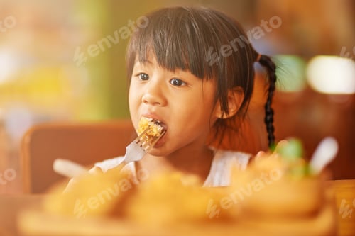 Preview: Pretty Thai little girl enjoying her food