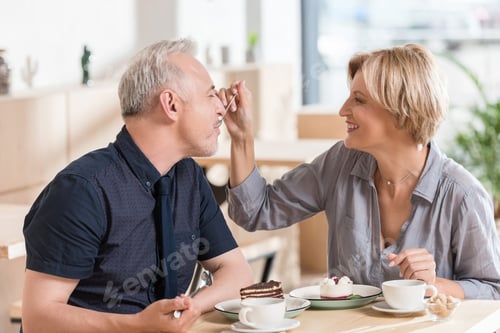 Preview: affectionate Couple eating sweets at cafe