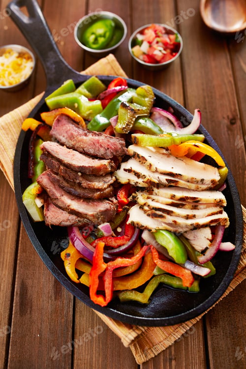 Preview: chicken and steak mexican fajitas in iron skillet