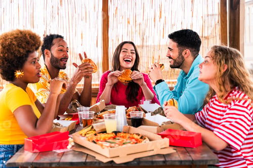 Preview: Multiethnic group of friends having dinner barbecue party on rooftop at home