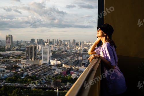 Preview: caucasian woman in trendy panama and waist neon bag on roof
