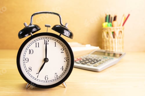 Preview: 7 AM Clock on work desk in the office Time of business working
