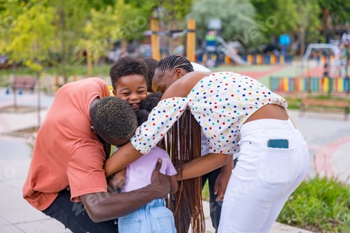 Preview: African black ethnic family with children in playground, hugging after school