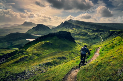 Preview: Mountain biker riding through rough mountain landscape of Quiraing, Scotland