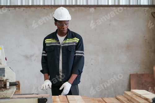 Preview: Young black man working at lumber distribution warehouse.