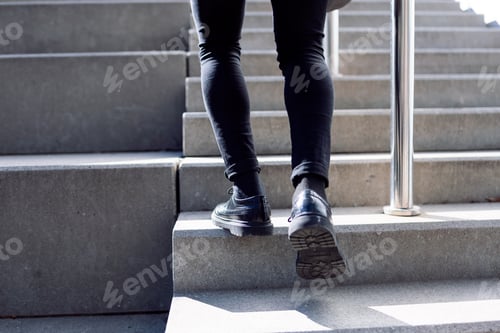 Preview: Crop male legs walking on stairs