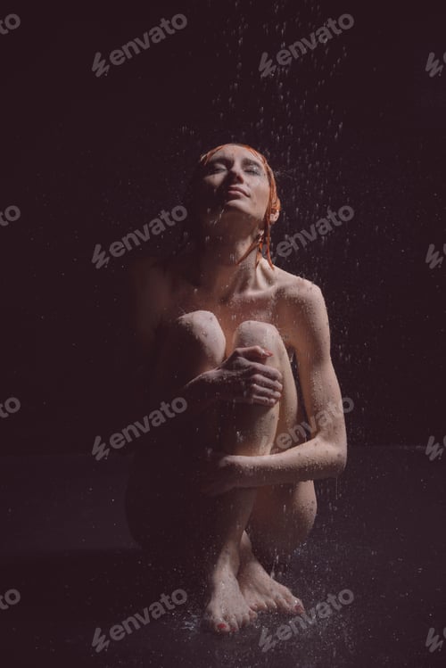 Preview: A Girl Sits On The Floor In The Rain.