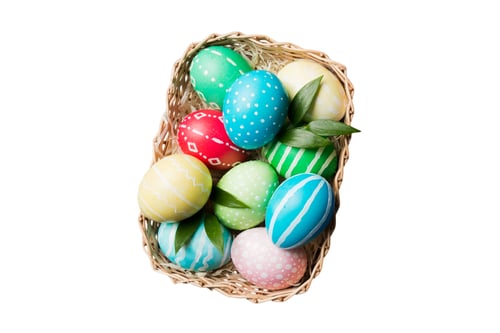Preview: Colorful Hand-Painted Easter Eggs in a Wicker Basket Isolated on White