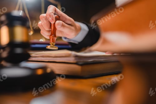 Preview: businessman or lawyer put a success stamp on legal deal contract in office, approved on certificate