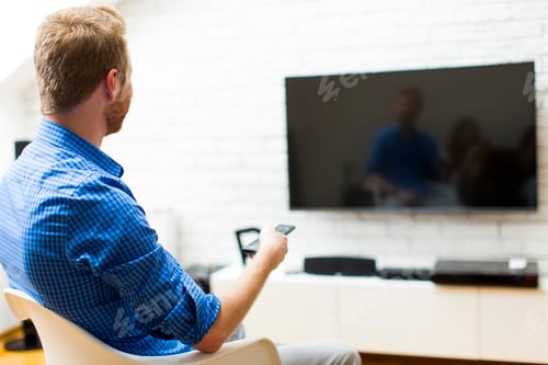 Preview: Man with a tv remote control