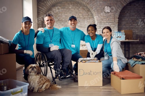 Preview: Team of happy diverse volunteers and dog at humanitarian aid center.