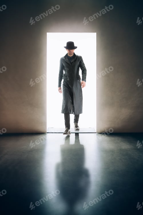 Preview: Man silhouette coming from the light of opening door in dark room