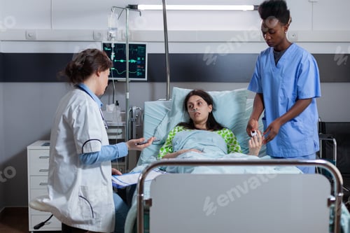 Preview: Sick woman resting in bed discussing with medical team sickness symptom