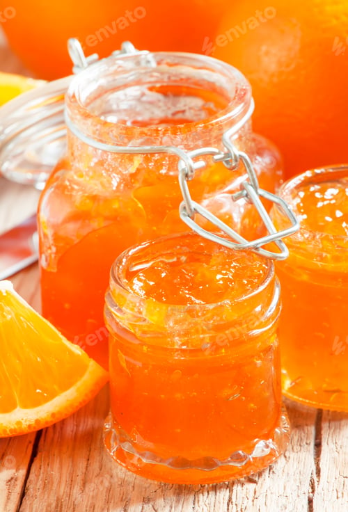 Preview: Orange jam and fresh oranges, vintage wooden table, selective focus