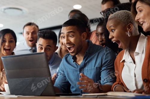 Preview: Shot of a group of young businesspeople using a laptop and looking shocked in a modern office