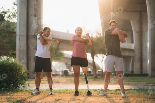 Preview: Woman exercising in a park with a friend providing support while using a prosthetic leg.