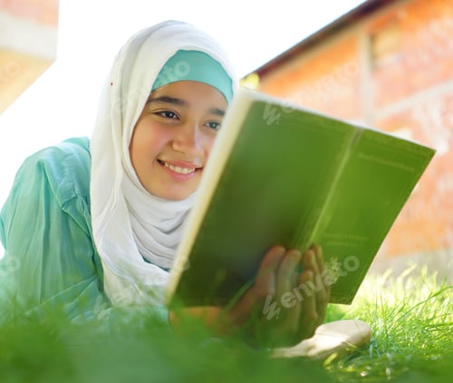 Preview: Beautiful Muslim Girl Reading Book With Hijab And Smiling