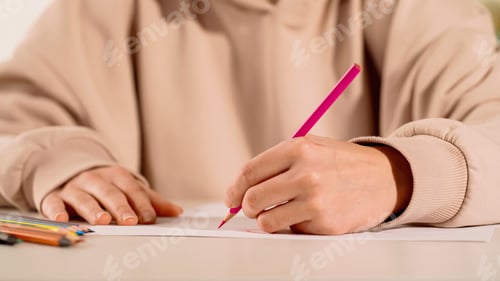 Preview: Cropped view of woman drawing with color pencil at home