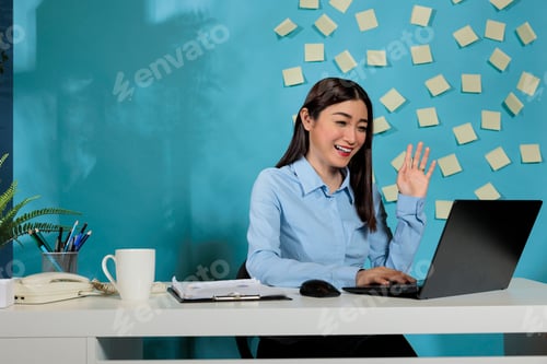 Preview: Female employee having a video call with friends with laptop