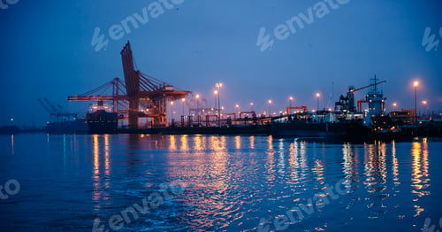 Preview: Distant view of cargo ship and gantry cranes in harbor at night, Tacoma, Washington, USA