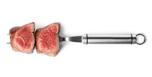 Preview: Carving fork with slices of delicious beef tenderloin isolated on white, top view