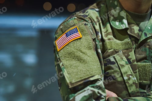 Preview: Cropped shot of a soldier wearing camouflage fatigues with an american flag for a patch