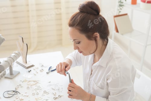 Preview: Professional jewelry designer making handmade jewelry in studio workshop. Fashion, creativity and